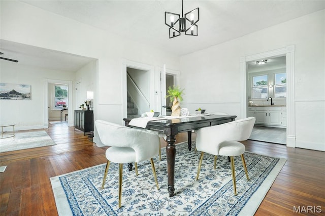 126 N Union St, Staunton, IL 62088 - dining area with stairs, dark wood-style floors, and a chandelier