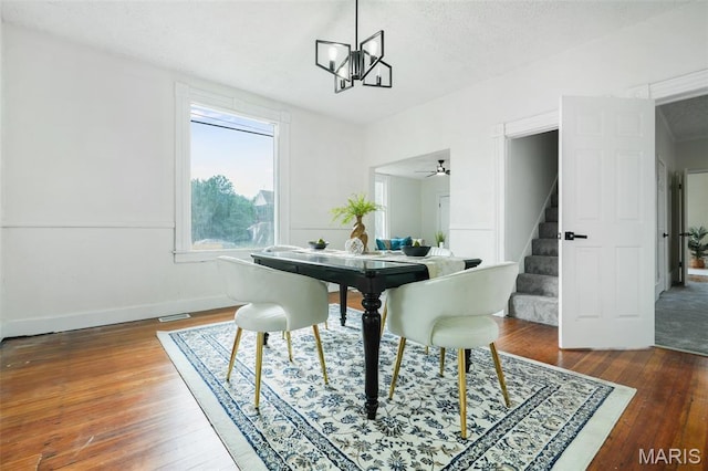 126 N Union St, Staunton, IL 62088 - dining area with stairs, hardwood / wood-style floors, a chandelier, and a textured ceiling