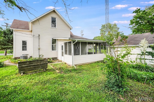 126 N Union St, Staunton, IL 62088 - back of property with a sunroom, a lawn, and roof with shingles