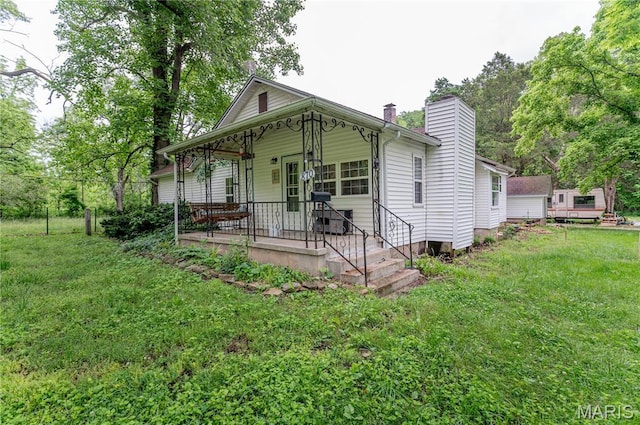 870 Walnut St, Newburg, MO 65550 - view of front of house featuring a chimney, covered porch, and a front yard