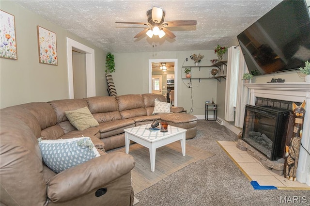 870 Walnut St, Newburg, MO 65550 - carpeted living area featuring a ceiling fan, a textured ceiling, and a fireplace with flush hearth