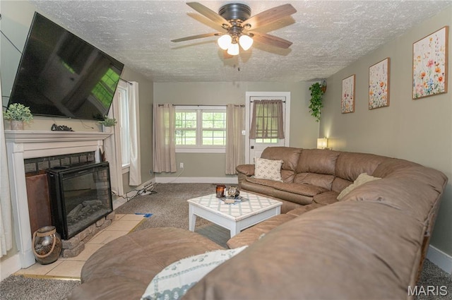 870 Walnut St, Newburg, MO 65550 - carpeted living area with ceiling fan, a textured ceiling, a fireplace with flush hearth, and baseboards