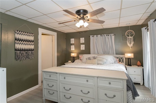 870 Walnut St, Newburg, MO 65550 - bedroom with light wood-style flooring, a drop ceiling, and a ceiling fan