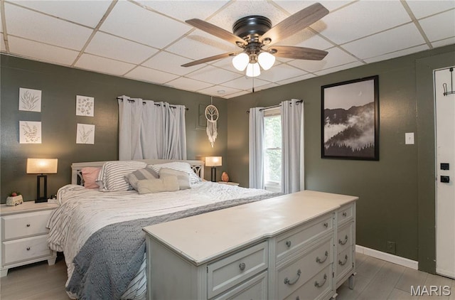 870 Walnut St, Newburg, MO 65550 - bedroom with a drop ceiling, light wood-style floors, ceiling fan, and baseboards