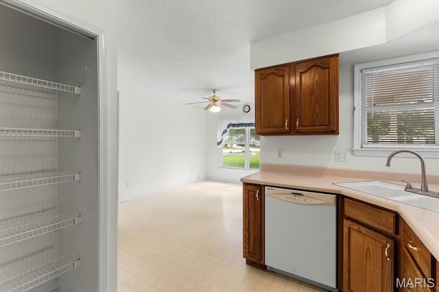 1500 Birch Ct, Edwardsville, IL 62025 - kitchen with white dishwasher, a sink, ceiling fan, light floors, and light countertops