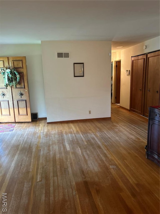 1548 Bayonne Dr, Saint Louis, MO 63138 - unfurnished living room featuring hardwood / wood-style flooring and baseboards