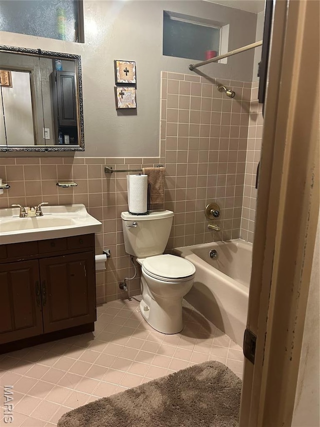 1548 Bayonne Dr, Saint Louis, MO 63138 - bathroom with vanity, toilet, shower / bathtub combination, tile patterned flooring, and tile walls