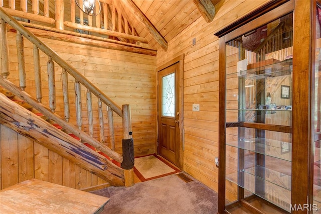 31511 Bowman Station Rd, Jerseyville, IL 62052 - foyer entrance featuring lofted ceiling, wooden walls, wood ceiling, carpet flooring, and stairs