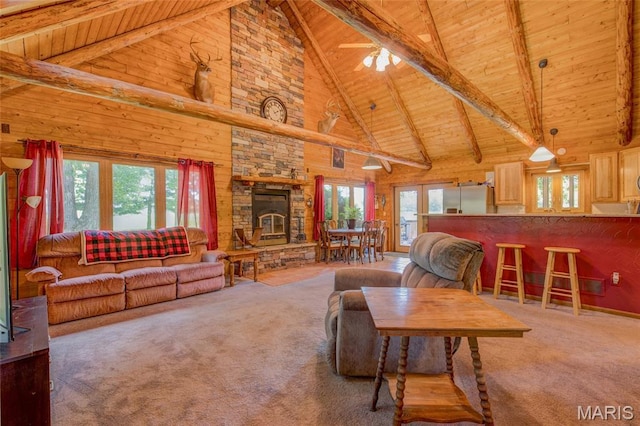31511 Bowman Station Rd, Jerseyville, IL 62052 - living area featuring wood ceiling with exposed beams, high vaulted ceiling, healthy amount of natural light, carpet, and wood walls