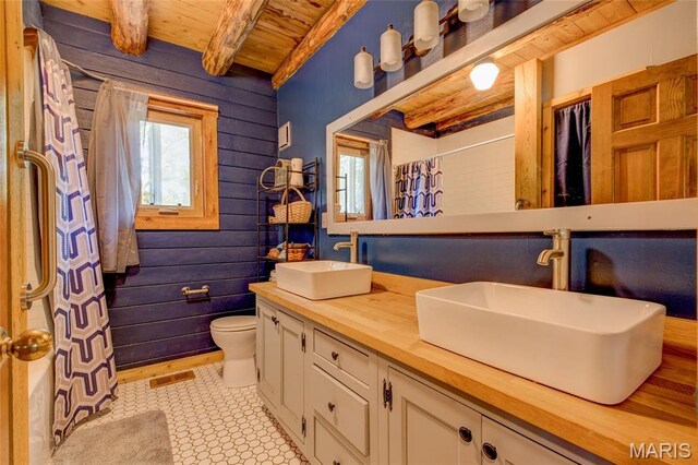 31511 Bowman Station Rd, Jerseyville, IL 62052 - bathroom with wooden ceiling with exposed beams, toilet, double vanity, curtained shower, and wooden walls