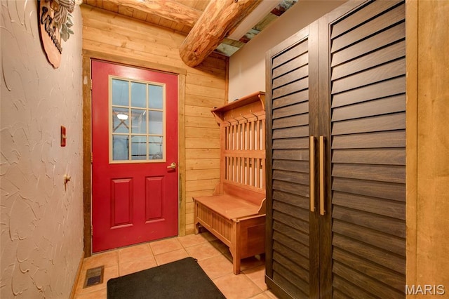 31511 Bowman Station Rd, Jerseyville, IL 62052 - mudroom featuring beam ceiling, light tile patterned flooring, and wooden walls