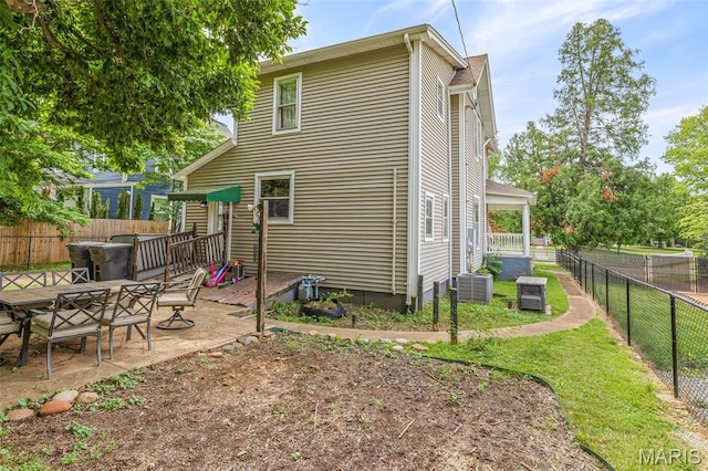 805 W Columbia St, Farmington, MO 63640 - back of property with a fenced backyard, central AC unit, a patio area, and outdoor dining area