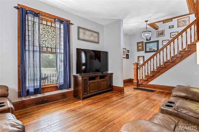 805 W Columbia St, Farmington, MO 63640 - living area with light wood-type flooring, stairs, baseboards, and a chandelier
