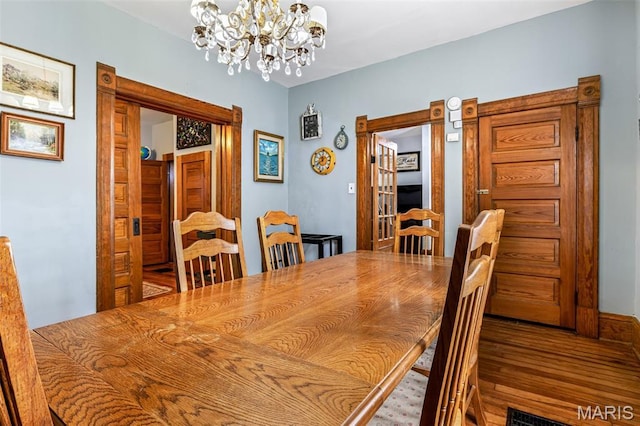 805 W Columbia St, Farmington, MO 63640 - dining room featuring a chandelier, wood finished floors, and baseboards