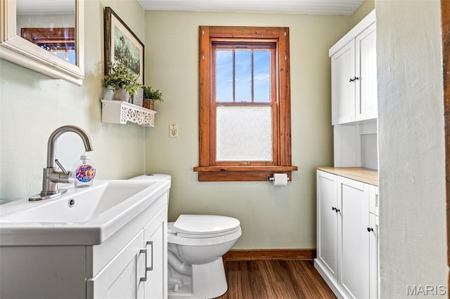 805 W Columbia St, Farmington, MO 63640 - bathroom featuring vanity, toilet, wood finished floors, and baseboards