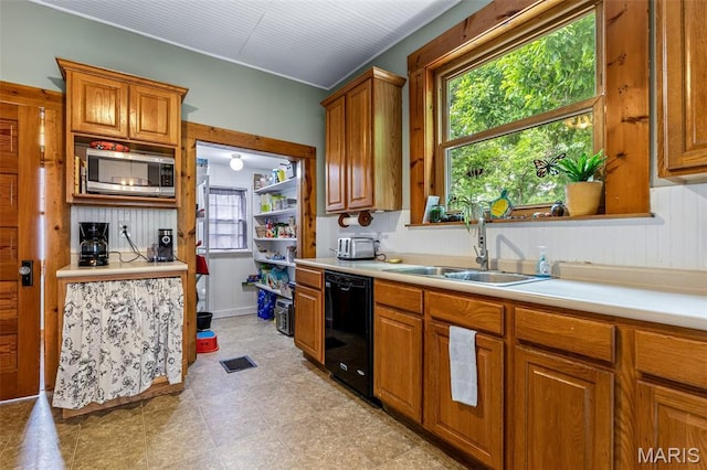 805 W Columbia St, Farmington, MO 63640 - kitchen featuring dishwasher, stainless steel microwave, light countertops, and a sink
