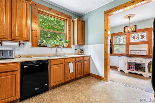 805 W Columbia St, Farmington, MO 63640 - kitchen featuring dishwasher, a sink, plenty of natural light, brown cabinets, and a wainscoted wall
