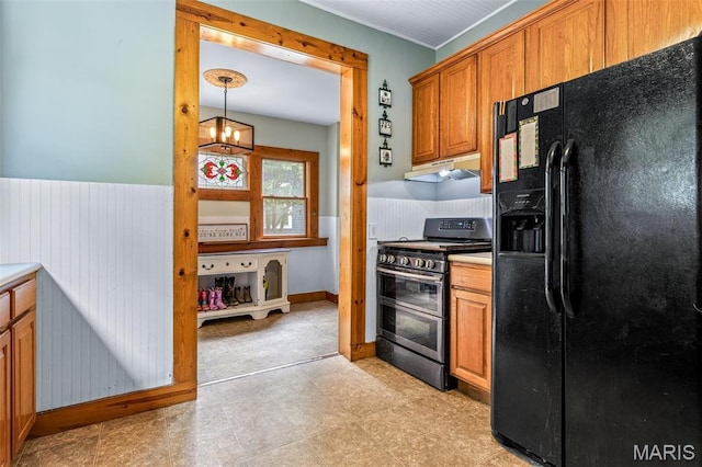 805 W Columbia St, Farmington, MO 63640 - kitchen with black fridge, double oven range, under cabinet range hood, a chandelier, and brown cabinetry