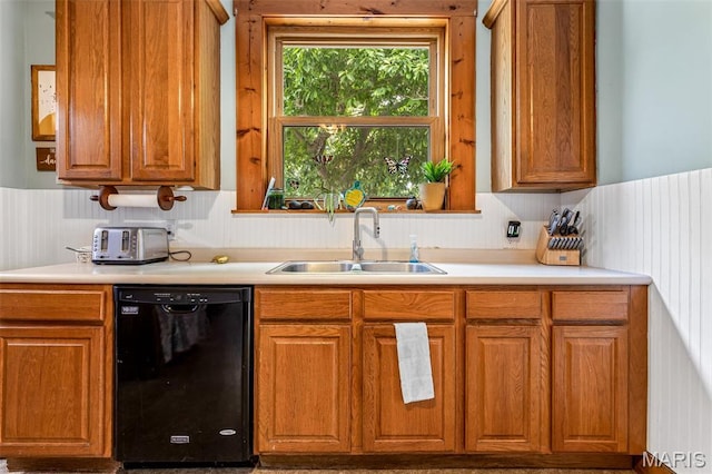 805 W Columbia St, Farmington, MO 63640 - kitchen featuring dishwasher, a sink, brown cabinetry, and a wainscoted wall