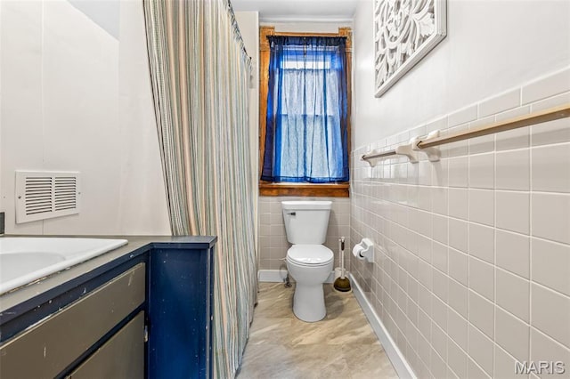 805 W Columbia St, Farmington, MO 63640 - bathroom featuring toilet, tile walls, and vanity