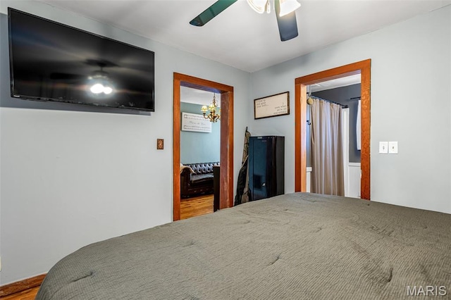 805 W Columbia St, Farmington, MO 63640 - bedroom featuring wood finished floors, a ceiling fan, and a chandelier