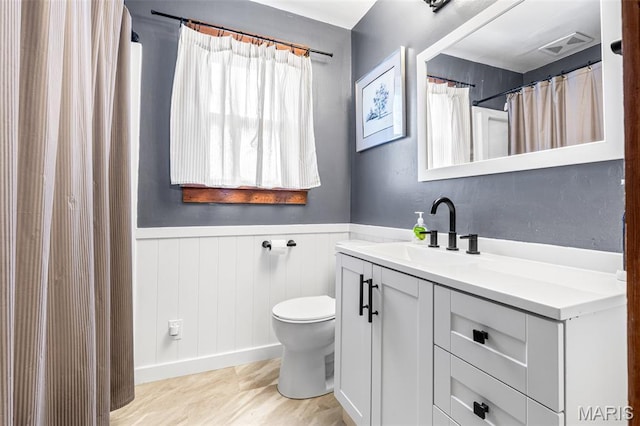 805 W Columbia St, Farmington, MO 63640 - bathroom featuring toilet, vanity, and a wainscoted wall