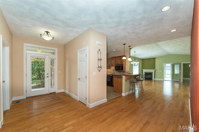 1812 Carrington Way, Belleville, IL 62226 - foyer entrance with light wood-style flooring, baseboards, lofted ceiling, recessed lighting, and a glass covered fireplace