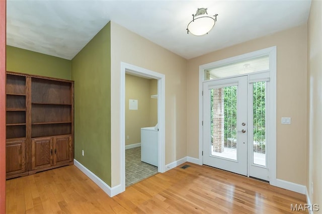 1812 Carrington Way, Belleville, IL 62226 - foyer with light wood-style flooring, washer / clothes dryer, and baseboards
