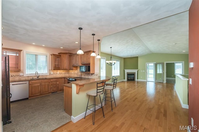 1812 Carrington Way, Belleville, IL 62226 - kitchen featuring black appliances, a sink, a breakfast bar area, brown cabinetry, and open floor plan