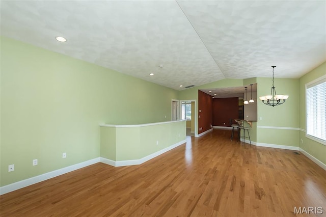 1812 Carrington Way, Belleville, IL 62226 - unfurnished living room featuring a chandelier, baseboards, wood finished floors, vaulted ceiling, and recessed lighting
