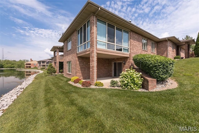 1812 Carrington Way, Belleville, IL 62226 - rear view of house with brick siding, a lawn, and a patio area