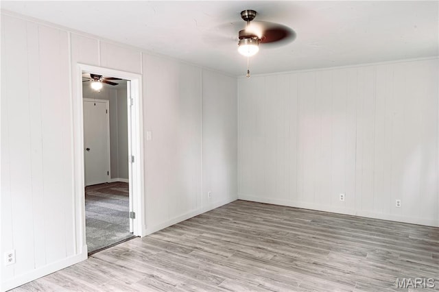 168 Elbring Dr, Hazelwood, MO 63135 - empty room with a ceiling fan, wood finished floors, a decorative wall, and baseboards