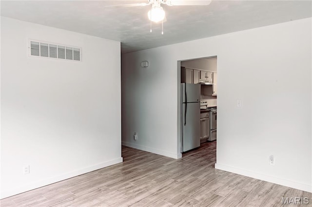 168 Elbring Dr, Hazelwood, MO 63135 - spare room with a ceiling fan, light wood-style flooring, and baseboards