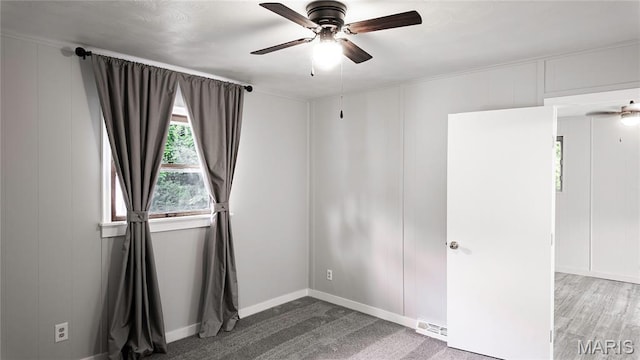 168 Elbring Dr, Hazelwood, MO 63135 - spare room with a decorative wall, a ceiling fan, and baseboards