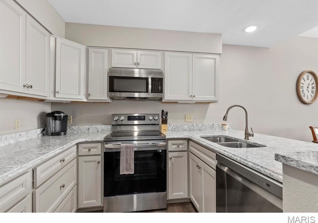 96 Geneva View Dr, Innsbrook, MO 63390 - kitchen with stainless steel appliances, a sink, light stone countertops, white cabinetry, and recessed lighting