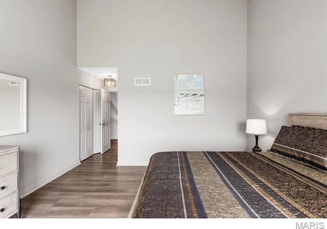 96 Geneva View Dr, Innsbrook, MO 63390 - bedroom with wood finished floors and a towering ceiling