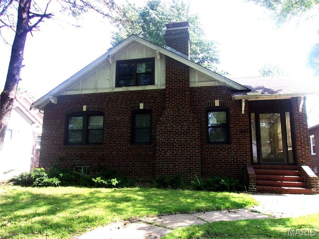 7622 Springdale Dr, Pasadena Park, MO 63121 - view of home's exterior with brick siding, a chimney, a lawn, entry steps, and central air condition unit