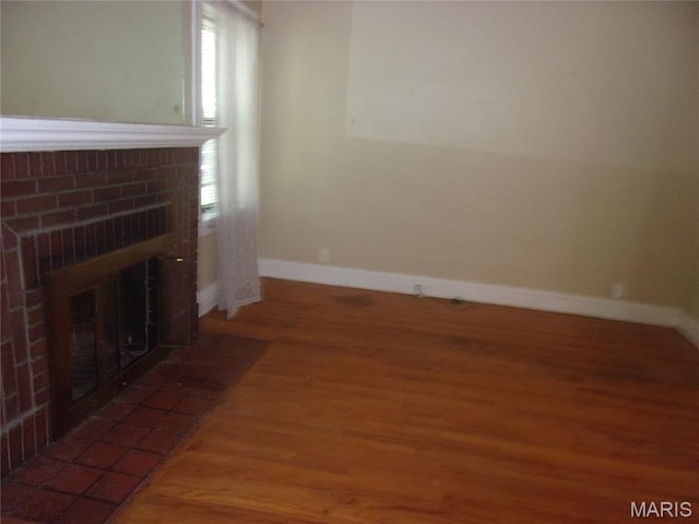 7622 Springdale Dr, Pasadena Park, MO 63121 - unfurnished living room featuring a fireplace, wood finished floors, and baseboards
