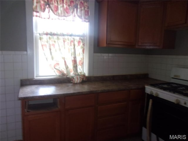 7622 Springdale Dr, Pasadena Park, MO 63121 - kitchen featuring range with gas stovetop and tile walls