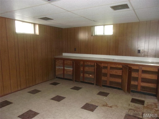 7622 Springdale Dr, Pasadena Park, MO 63121 - bar area featuring tile patterned floors, a drop ceiling, wood walls, and plenty of natural light