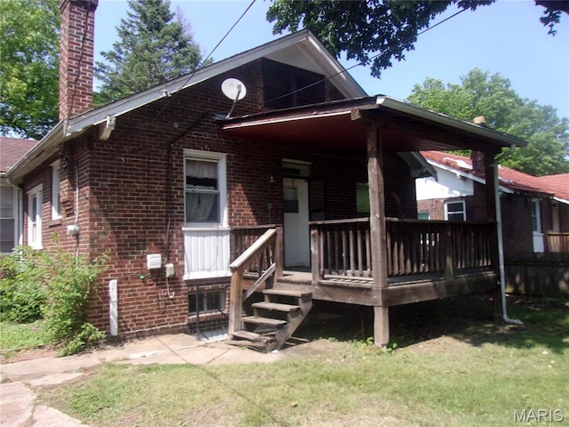 7622 Springdale Dr, Pasadena Park, MO 63121 - view of front of property with brick siding, a chimney, and a front yard
