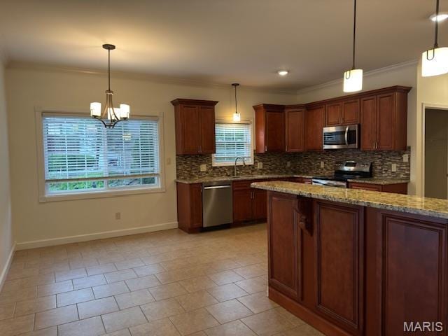 2063 Chesapeake Ave, Cape Girardeau, MO 63701 - kitchen with stainless steel appliances, ornamental molding, baseboards, backsplash, and light stone countertops