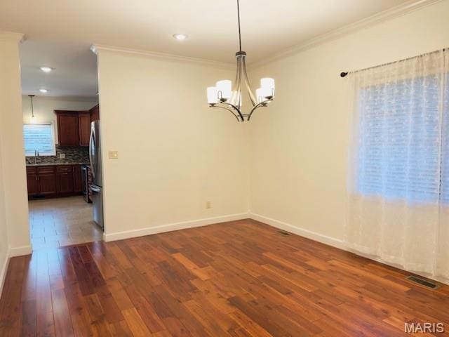 2063 Chesapeake Ave, Cape Girardeau, MO 63701 - empty room with ornamental molding, dark wood-type flooring, a chandelier, a sink, and baseboards