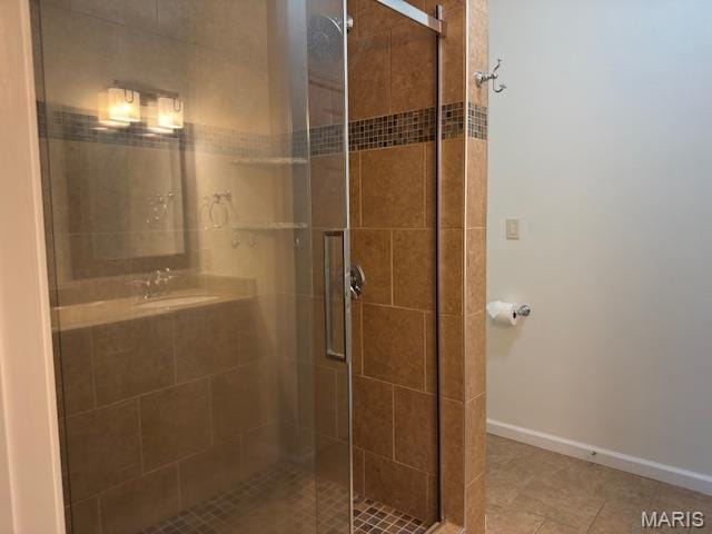 2063 Chesapeake Ave, Cape Girardeau, MO 63701 - full bathroom featuring a shower stall, a sink, tile patterned floors, and baseboards