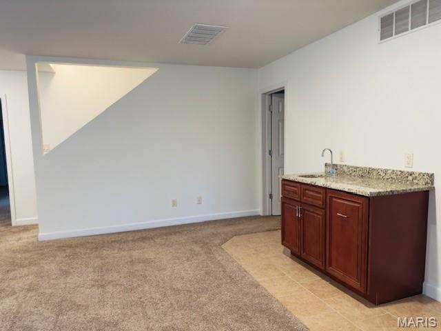 2063 Chesapeake Ave, Cape Girardeau, MO 63701 - bar area with a sink, light colored carpet, and baseboards