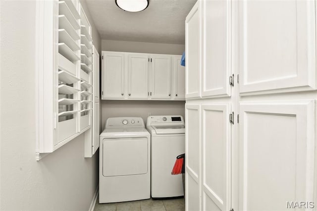 1522 S Oakland Ave, Bolivar, MO 65613 - laundry room featuring cabinet space, washer and clothes dryer, light tile patterned floors, and baseboards