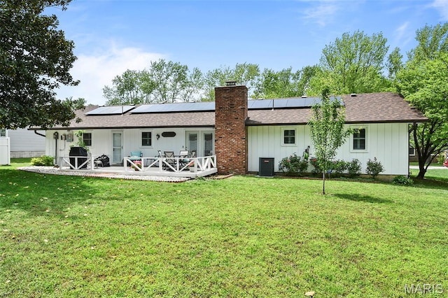 1522 S Oakland Ave, Bolivar, MO 65613 - rear view of house with a chimney, a yard, cooling unit, and roof with shingles