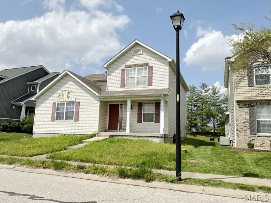 232 Harmony Ridge Dr, Belleville, IL 62220 - traditional-style house with covered porch and a front lawn