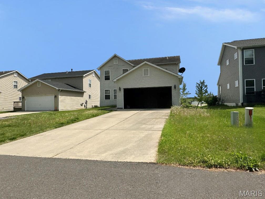 232 Harmony Ridge Dr, Belleville, IL 62220 - traditional home with an attached garage, a front yard, and driveway