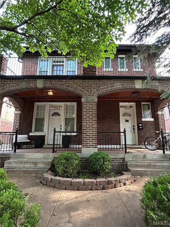 7049 Amherst, University City, MO 63130 - view of front of home with a porch and brick siding